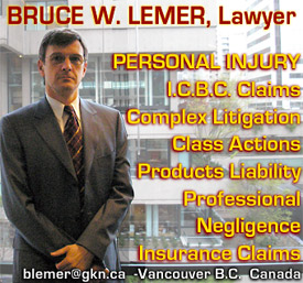 Bruce Lemer, standing at his office window overlooking downtown Vancouver BC Supreme Court building on Howe St. - handles  personal injury / product liability / professional negligence / class action legal cases