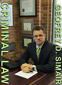 Geofrey Simair, Criminal Defense Lawyer at his desk near Downtown Bay Centre in Victoria, BC
